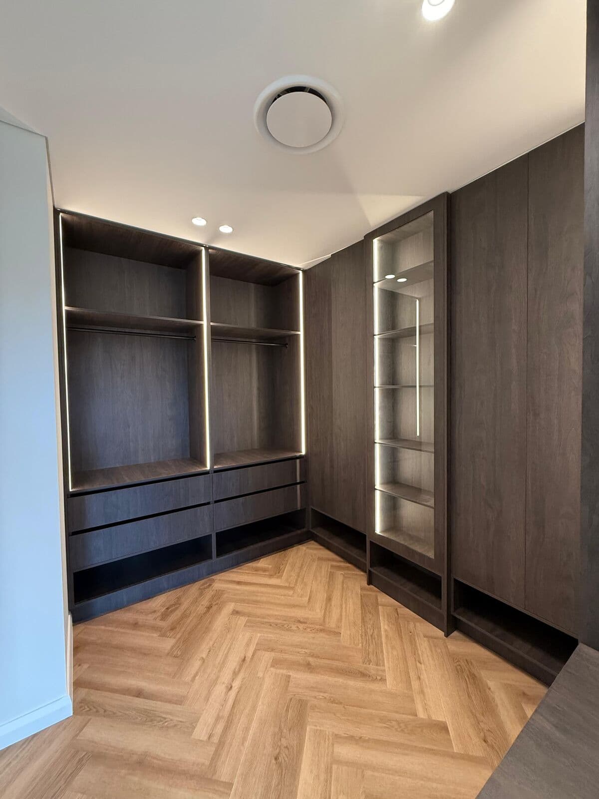 Timber-floored walk-in wardrobe and fitted cabinetry