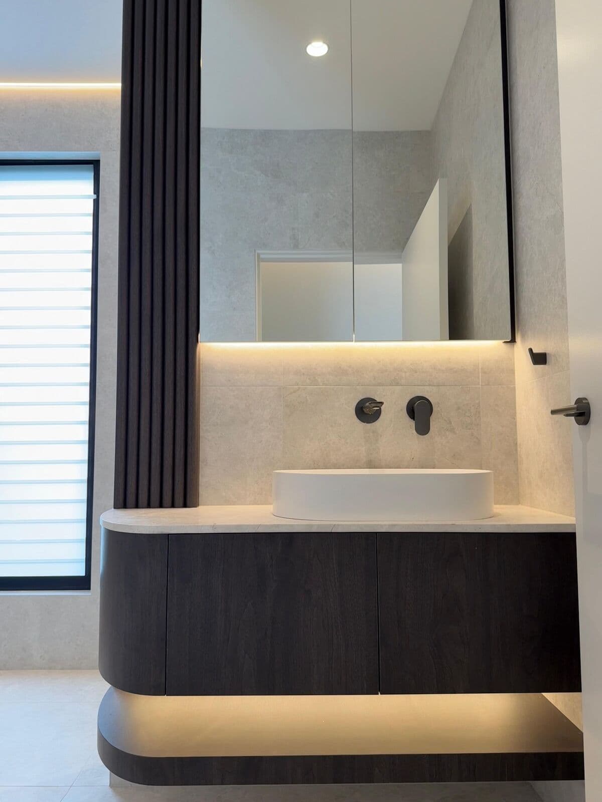 Bathroom vanity with lighting beneath the cabinet
