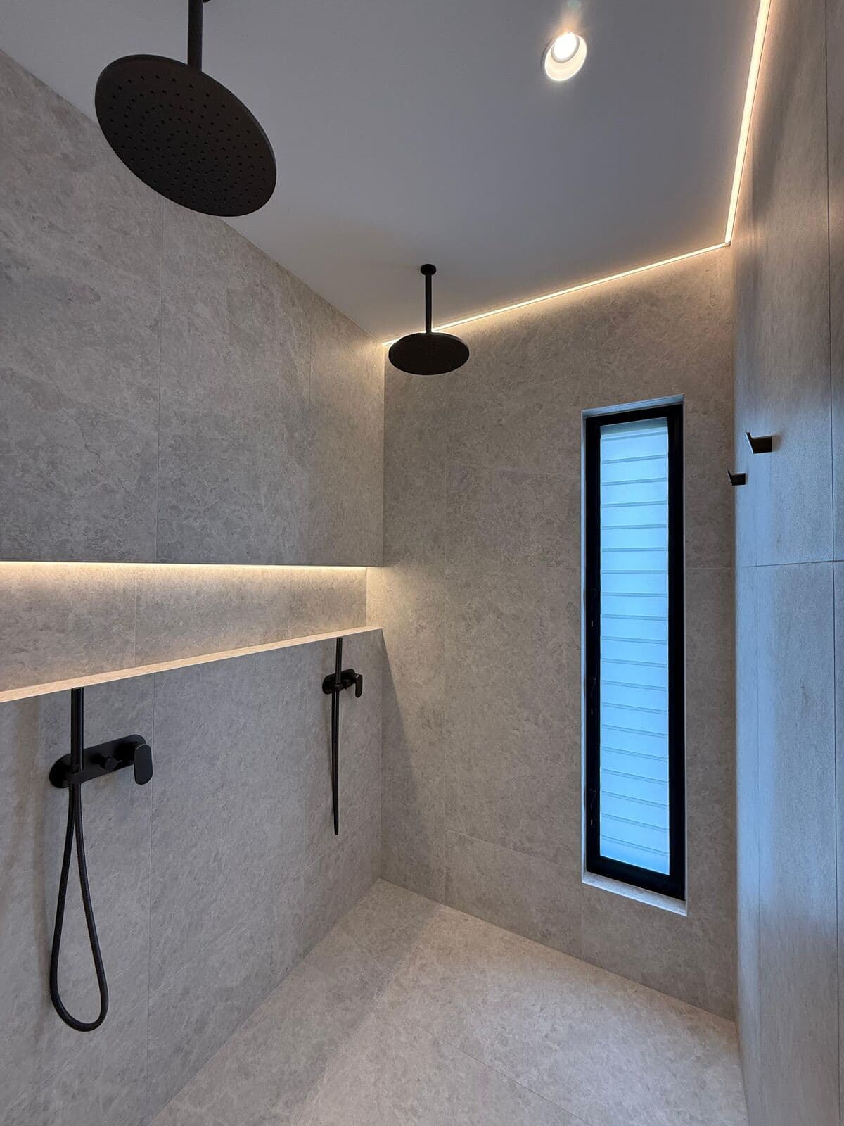 Bathroom ceiling with recessed lighting and shower fittings