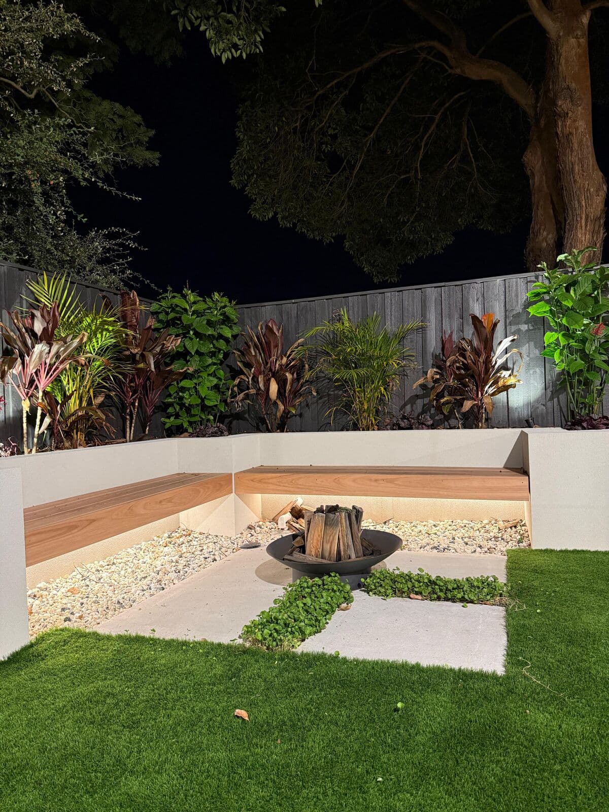 Garden seating and fire pit area with night-time lighting