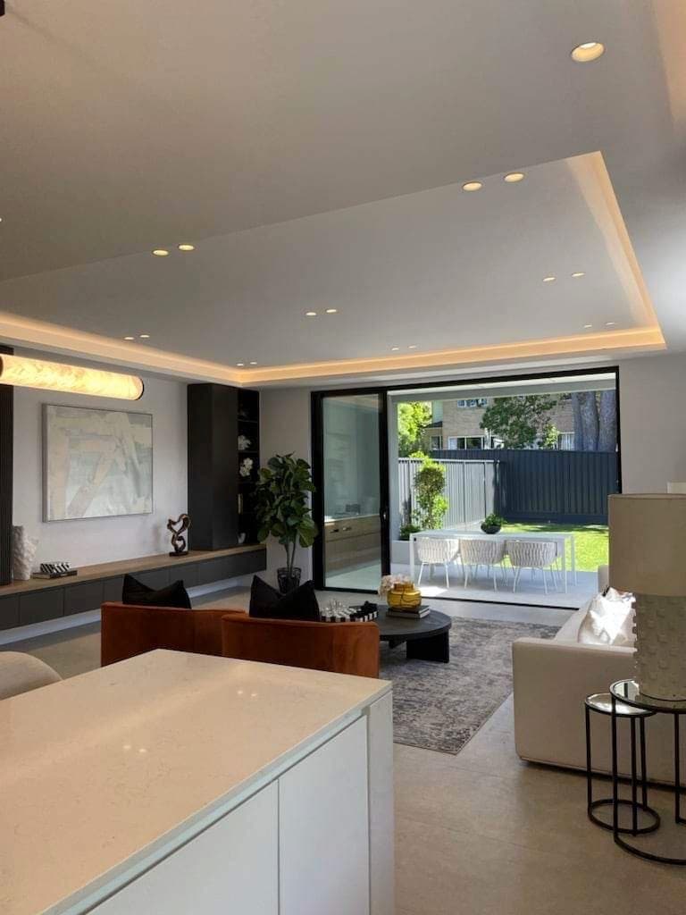 Kitchen and living area with ceiling perimeter lighting