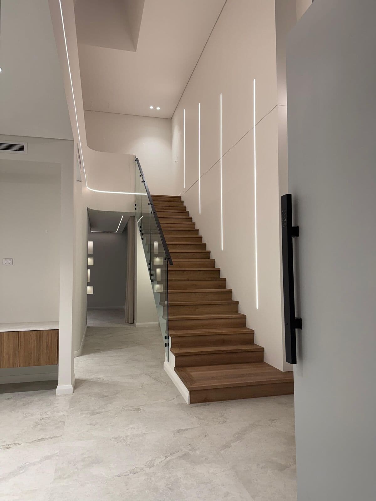 Interior hallway leading to a timber staircase