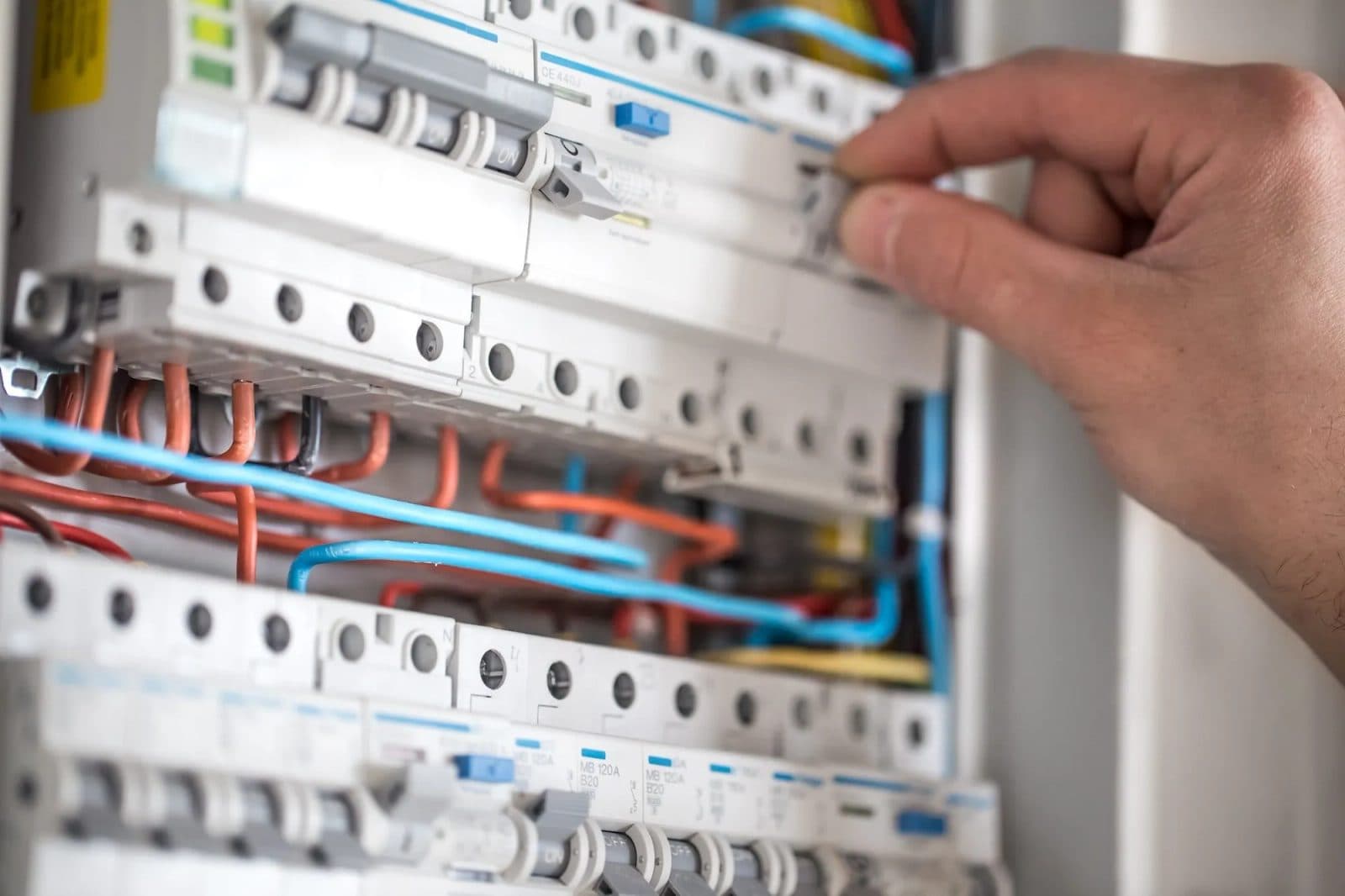 Hand switching a circuit breaker in a residential switchboard